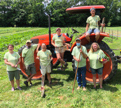 CFN Member Spotlight: Homefields Care Farm. (Image is of 7 Homefields team members in front of and on a tractor.)