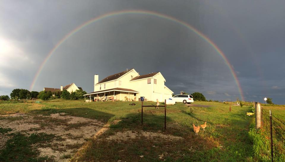 Rainbow over farmhouse