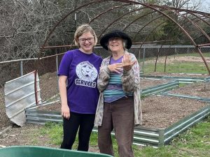 2 people standing in front of construction build