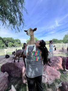 woman holding a goat up