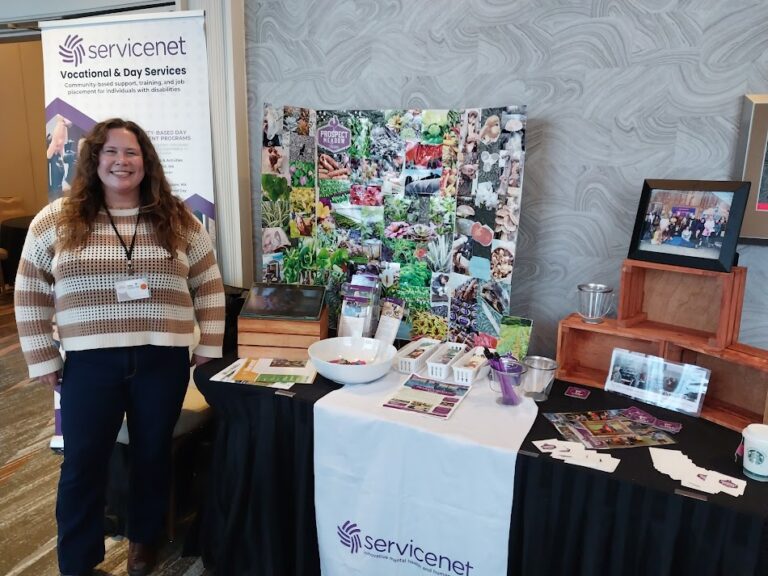 Exhibitor table with displays and brochures.