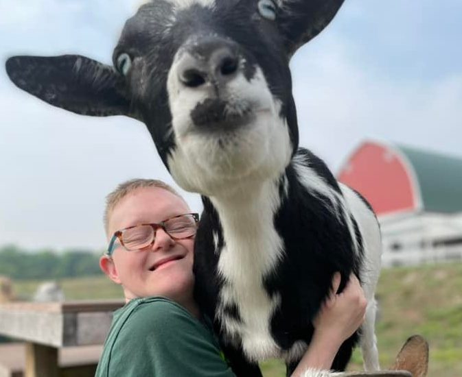 person hugging a goat!