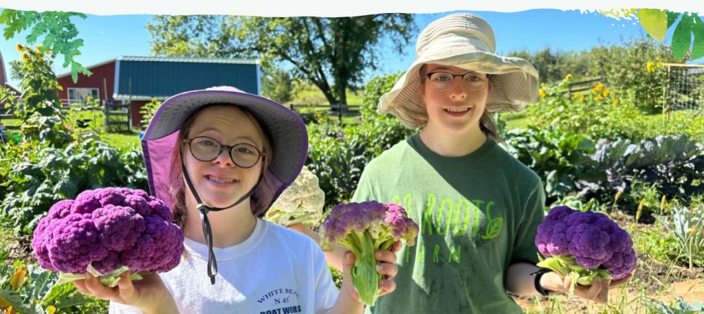 Girls holding vegetables