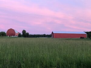Red barn with beautiful sky and field